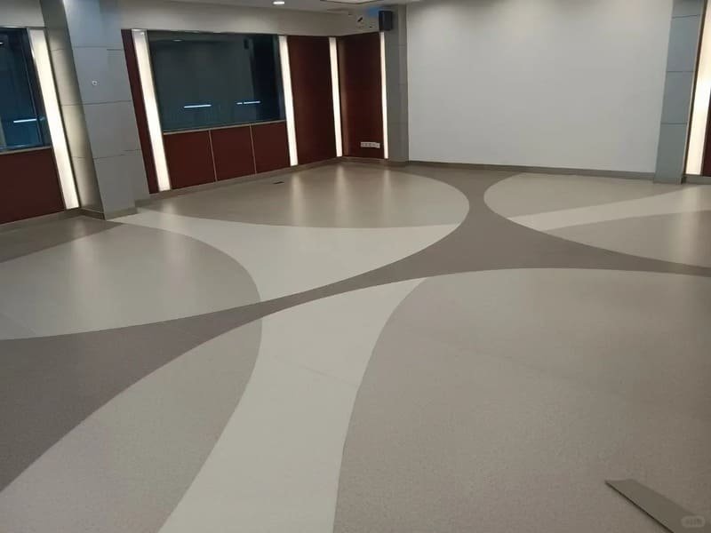 Installer performing finger test on PVC flooring adhesive